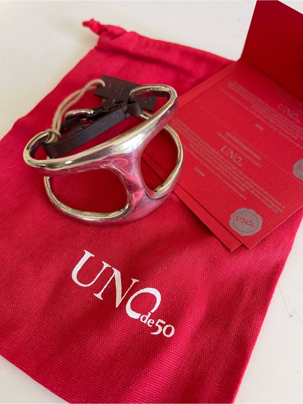 UNO de 50 Silver Tone Openwork Cuff Bracelet.  Comes with red gift bag.